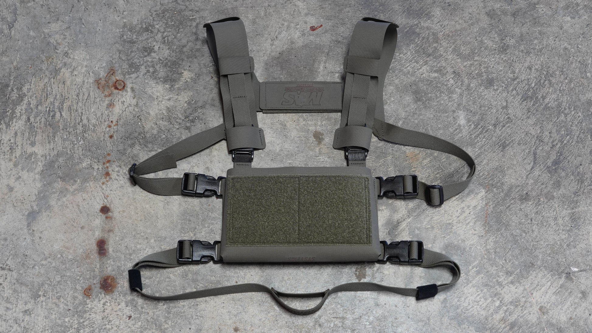 Back strap attached to chest rig placard showing adjustable fit and elastic section for comfort and stability during movement